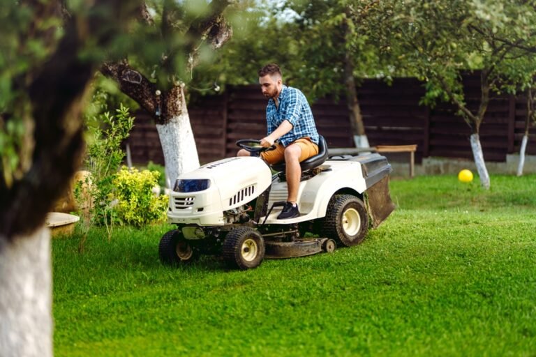 Portrait,of,gardener,using,a,lawn,mowing,tractor,for,cutting